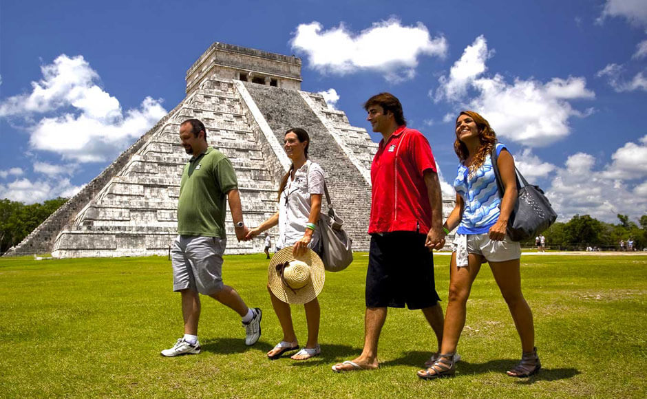 Two adult couples having a walk near Chichen Itza pyramid