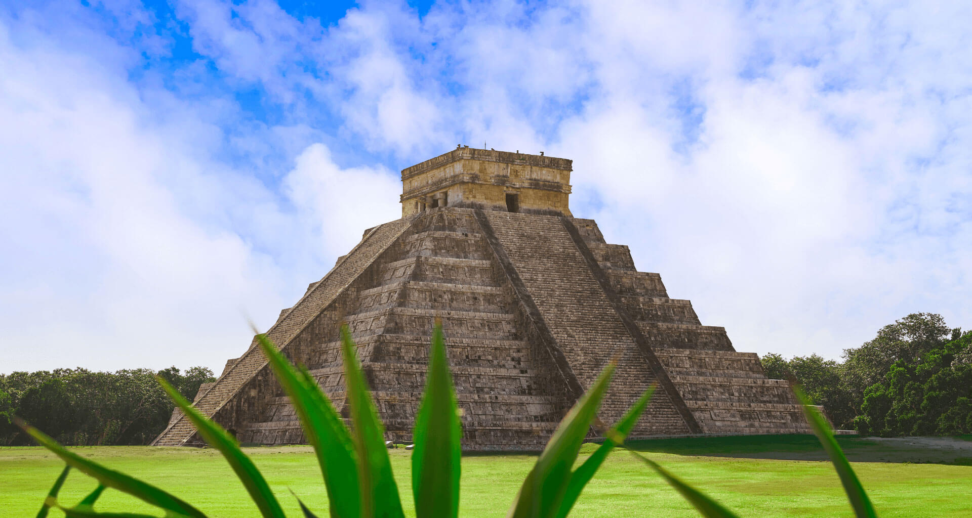 Chichen Itza pyramid, a 365-steps 4-sided building captured during night while stars shine in the sky